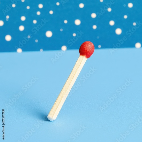 Isolated Matchstick with Red Tip on Light Blue Backdrop Still Life