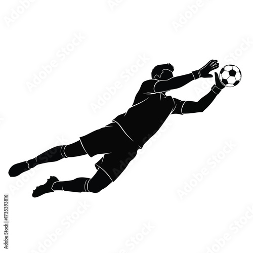 silhouette of a soccer goalkeeper diving for ball