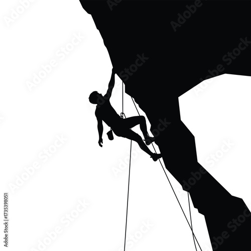 silhouette of a rock climber on a cliff