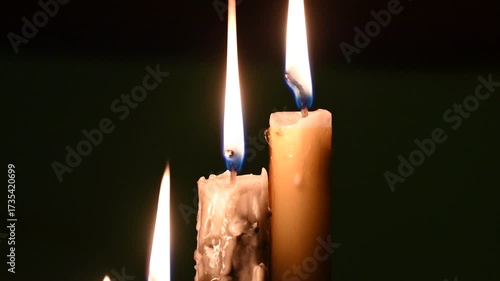 Candle flame close up on a dark background. Melted Wax Candle light border design. Burning at Night, Darkness. Candlelight.