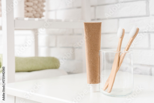 Toothpaste and glass cup wi...
