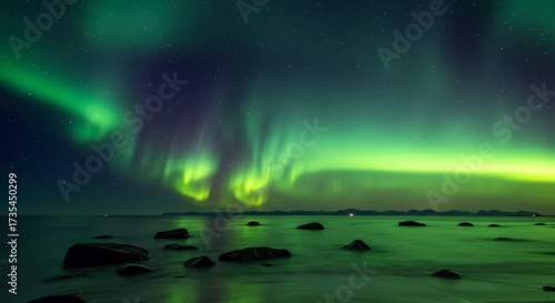 Wallpaper Mural Spectacular nighttime display of aurora borealis shimmering over tranquil waters with scattered rocks Torontodigital.ca