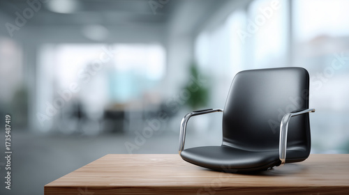 Modern black office chair on wooden desk in contemporary workspace with blurred background showcasing modern architecture and bright lighting