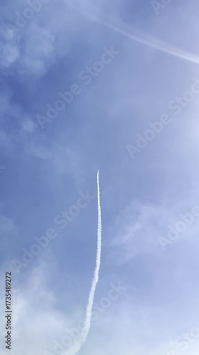 Ascending Vapor Trail in Azure Sky: A soaring vapor trail etches a delicate line across a vast expanse of azure sky, a testament to the power of flight and the boundless horizons of possibility.