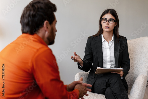 Counselor helping client with mental health discussion. Professional psychologist talking with man