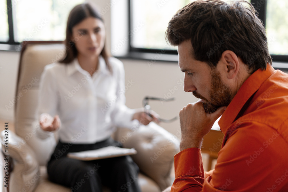 Fototapeta premium Stressed man discussing mental health during therapy session