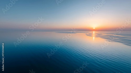 breathtaking aerial view of oceans surface at dawn showcasing smooth water reflecting suns rays