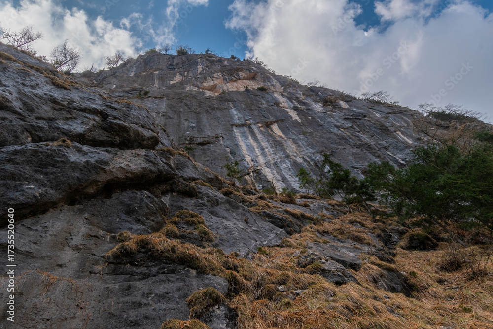 Obraz premium Steep alpine rock walls viewed from below in the Echerntal valley, Austria