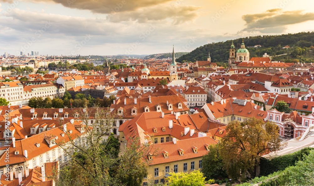 Fototapeta premium Evening light over historic towers and buildings in Prague, Czechia