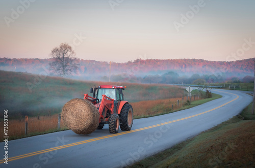 Rural Kentucky Autumn Morning: Tractor Transporting Hay Bale on