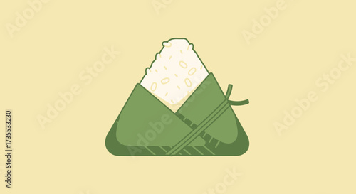 A green wrapped triangular food item on a yellow background.