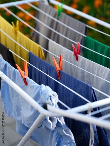 Washed laundry hanging on a clothing dryer rack outdoors