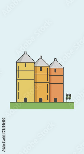 Three colorful silos stand on a green grassy field.