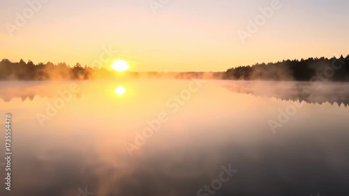 Wallpaper Mural ﻿Golden hour light bathes a serene, misty lake at sunrise, with gentle fog rolling over the calm water calming, meditative, tranquil Torontodigital.ca