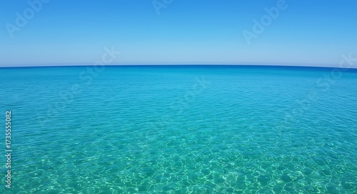 Tranquil turquoise ocean waters under a bright blue sky horizon