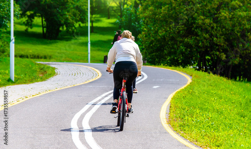 Wallpaper Mural Cyclist ride on the bike path in the city Park
 Torontodigital.ca
