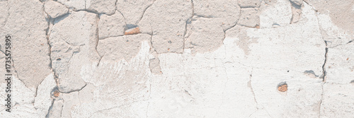 Concrete wall texture with cracked plaster. Weathered uneven rough surface. Perfect for background and grunge design.