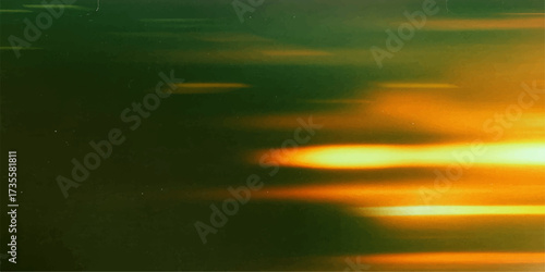 Sunset colors paint the beautiful landscape where the sun reflects on the ocean water, blending orange, blue, and yellow light in the evening sky cloudscape