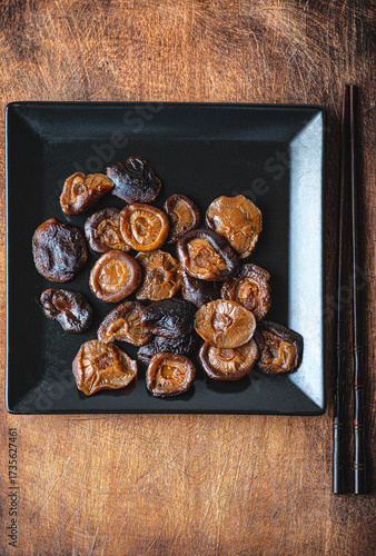 Japanese shiitake mushrooms marinated on rustic wooden background 