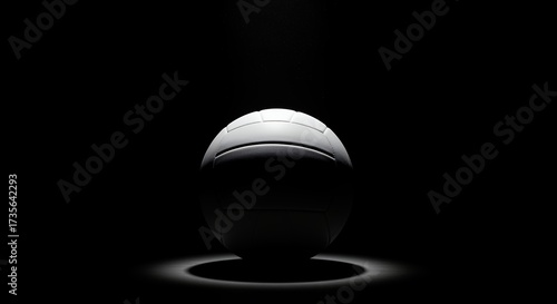 Volleyball illuminated center stage against black background dramatic lighting concept