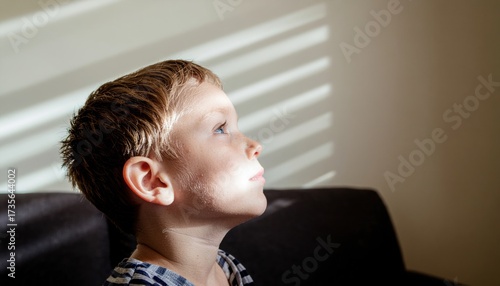 Young child in inventive daydream diagonals of projector texture neutral wall quiet atmosphere modern studio portrait for creativity learning and brand storytelling