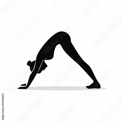Silhouette of a woman in downward-facing dog yoga pose.
