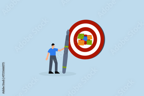 Goal setting, entrepreneur jots down objectives on paper and places them on large dartboard