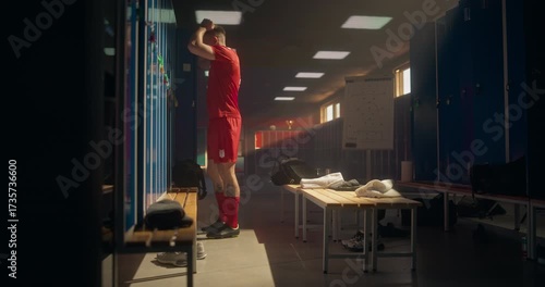 Frustrated Soccer Player Storms Back into the Locker Room, Throwing the Ball Aggressively Against the Wall. Athlete’s Anger Reflects Disappointment After a Tough Match and a Loss