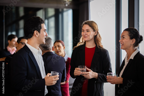Colleagues enjoying casual conversation during an offsite business event, reflecting organizational culture, partnership, and professional growth.