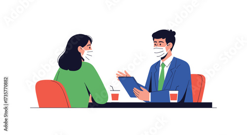 Two people wearing face masks having a discussion at a table.