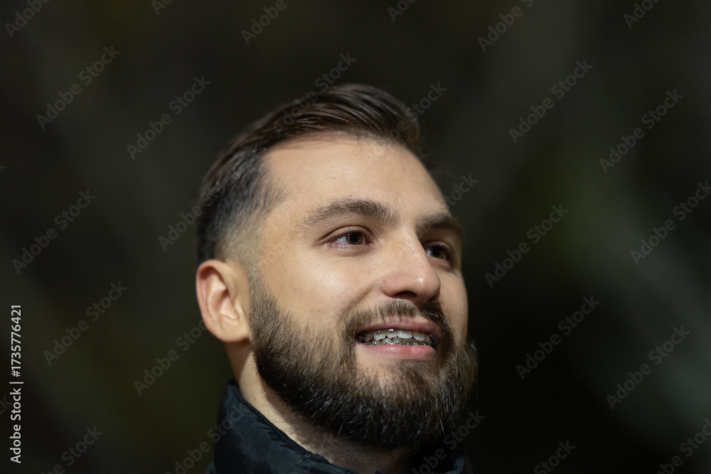 Fototapeta premium Young man smiling wearing dental braces looking up