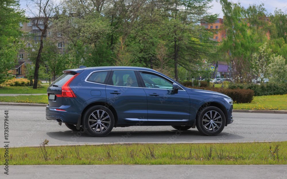 Fototapeta premium SUV moves along a city street