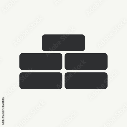 Wall construction featuring building blocks in gray. Construction shows stacked bricks, presenting masonry work in a simple design.