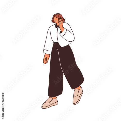 Woman walking and speaking on mobile phone. Young female going outdoors durin...