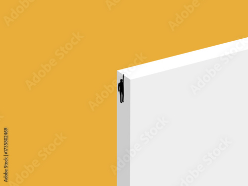 Businessman about to fall holds onto the edge of a cliff.