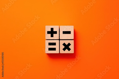 Wooden blocks with basic mathematical symbols for arithmetic on a bright orange background. A minimalist concept for education, finance, and problem-solving