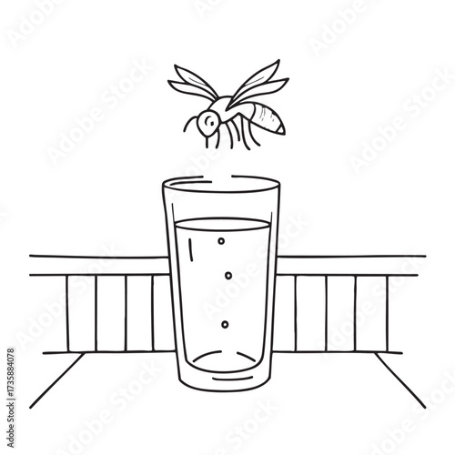 A wasp circling above a glass of juice on the balcony