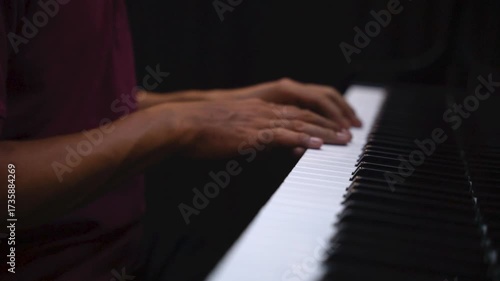 Close-Up of Hands Playing Piano Keys Under Low Light – Music Practice and Performance Concept