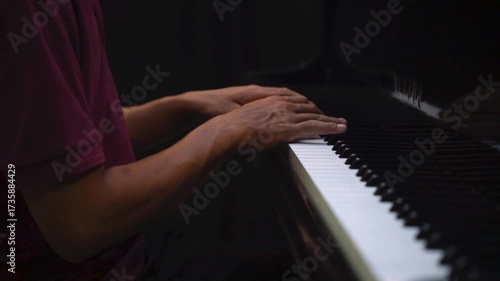 Close-Up of Hands Playing Piano Keys Under Low Light – Music Practice and Performance Concept