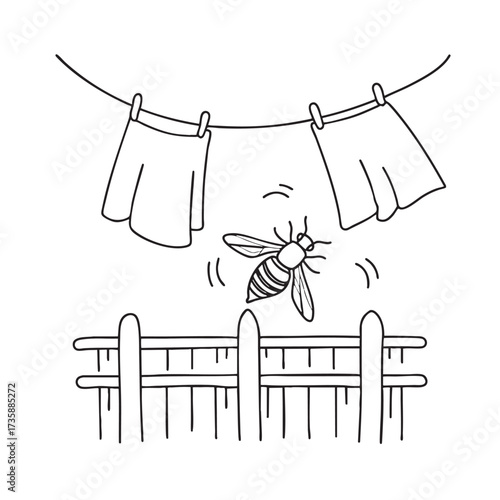 A wasp landing on a fence beside hanging laundry