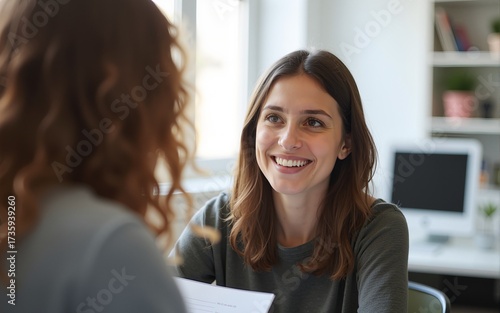 Teenage girl high school student talking with mentor, psychologist in office. High quality