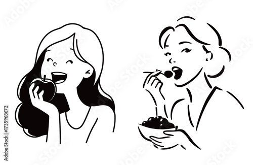 Two women happily eat healthy snacks. One is biting into a fresh apple while the other enjoys berries with chopsticks. Both are smiling with joy.