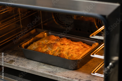 Freshly baked focaccia stands in the oven.