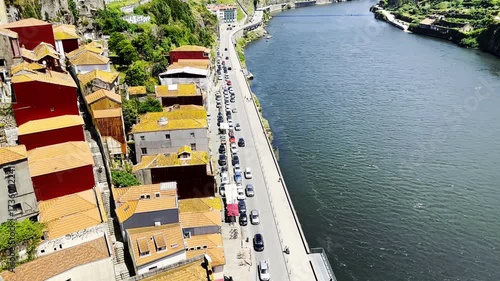 Aerial view of Douro River, car traffic at riverside, cluster of red