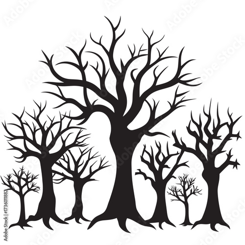 Silhouette of bare trees in a spooky forest