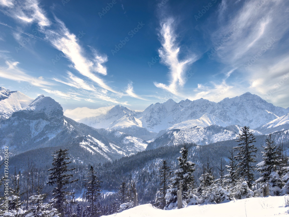 Fototapeta premium clouds over the snow-covered mountain peaks