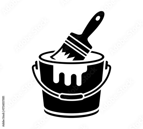 Paintbrush dipping into a bucket of white paint, creative concept