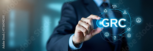 Businessman interacts with GRC icons on digital interface representing governance risk management compliance and business ethics in organizational management. concept as Businessman interacts with GRC