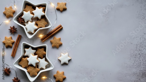 Top-down holiday treat display with star-shaped gingerbread and sugar cookies in white ceramic bowls