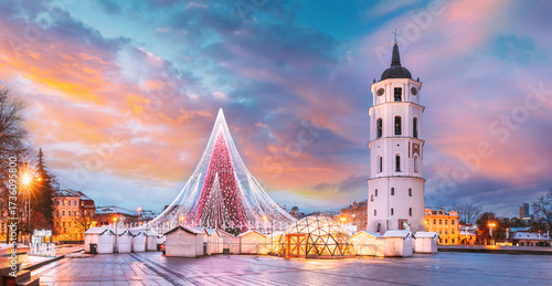Vilnius, Lithuania. Christmas Tree On Background Bell Tower Belfry Of Vilnius Cathedral At Cathedral Square In Evening New Year Christmas Xmas Illuminations. Unesco World Heritage Site. Altered Sky